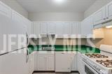 160 Durham Avenue, Unit 305 Metuchen, NJ 08840 - Photo 32 of 39 a kitchen with white cabinets and a stove