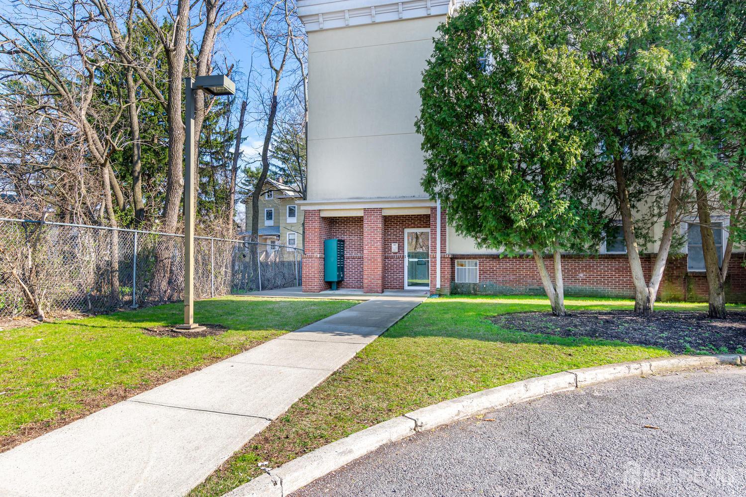 160 Durham Avenue, Unit 305 Metuchen, NJ 08840 - Photo 4 of 39 a house that has a tree in front of it