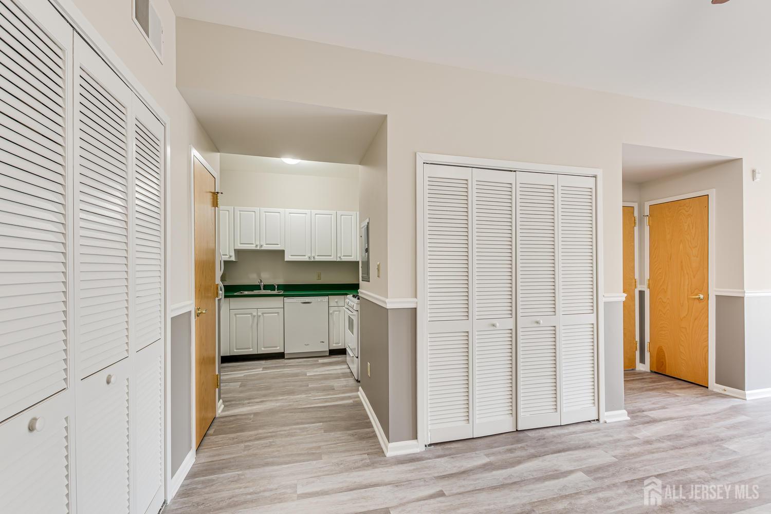 160 Durham Avenue, Unit 305 Metuchen, NJ 08840 - Photo 6 of 39 a kitchen with a refrigerator and white cabinets