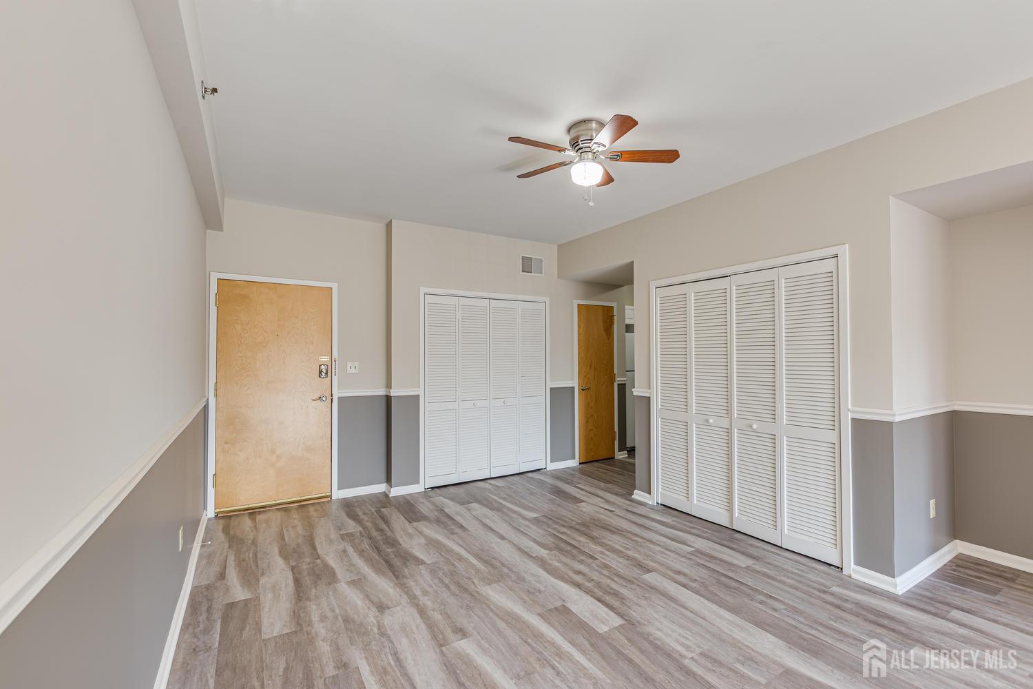 160 Durham Avenue, Unit 305 Metuchen, NJ 08840 - Photo 7 of 39 a view of empty room with wooden floor and fan