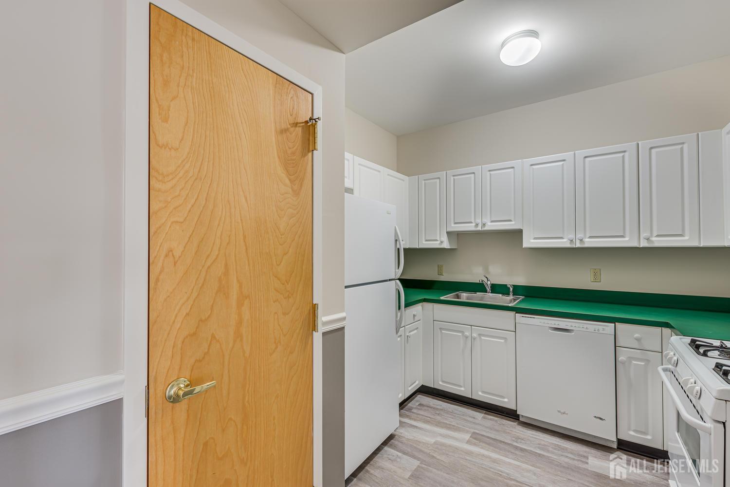 160 Durham Avenue, Unit 305 Metuchen, NJ 08840 - Photo 9 of 39 a kitchen with stainless steel appliances granite countertop white cabinets and a refrigerator