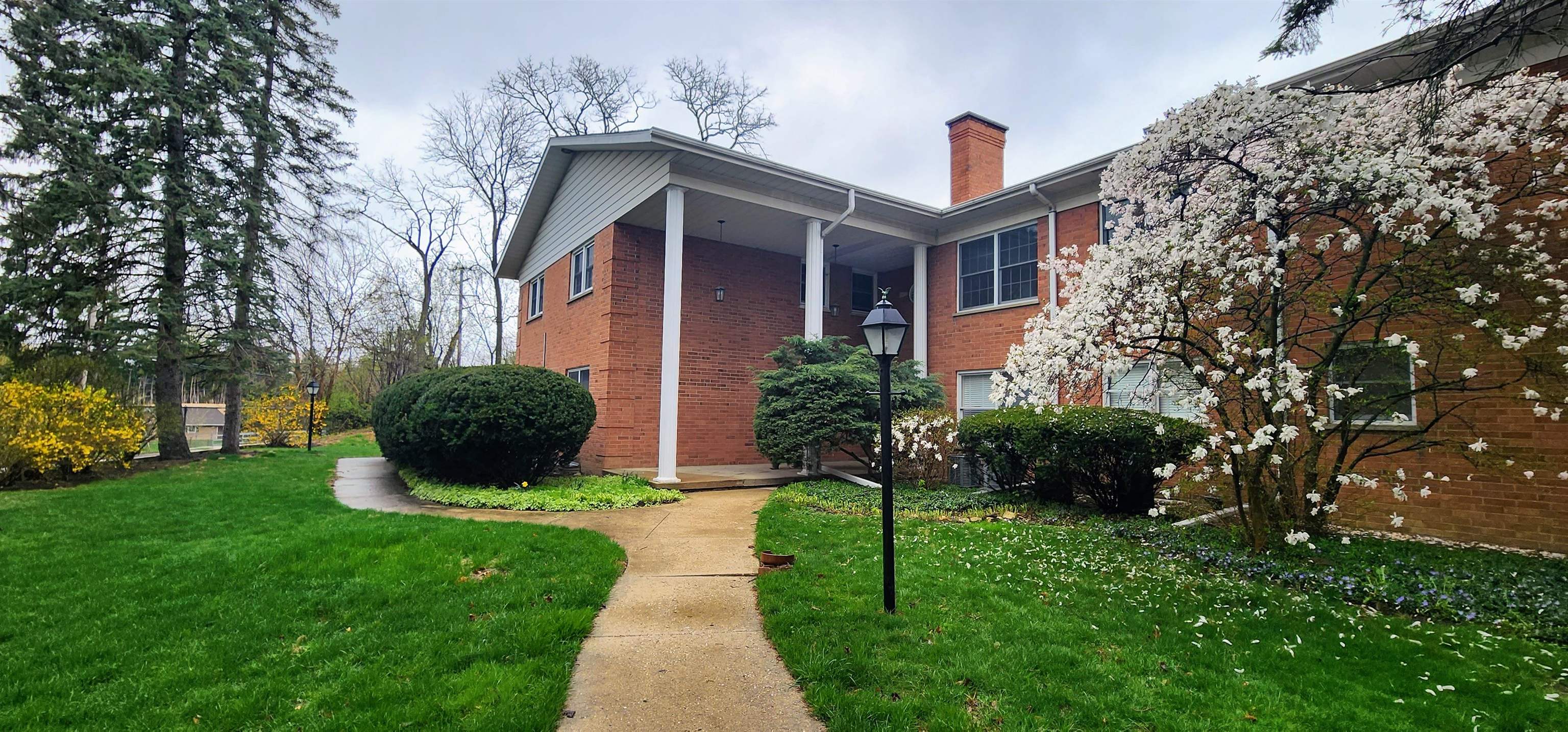 1450 Wing Street Elgin, IL 60123 - Photo 2 of 36 a front view of a house with a yard and seating space
