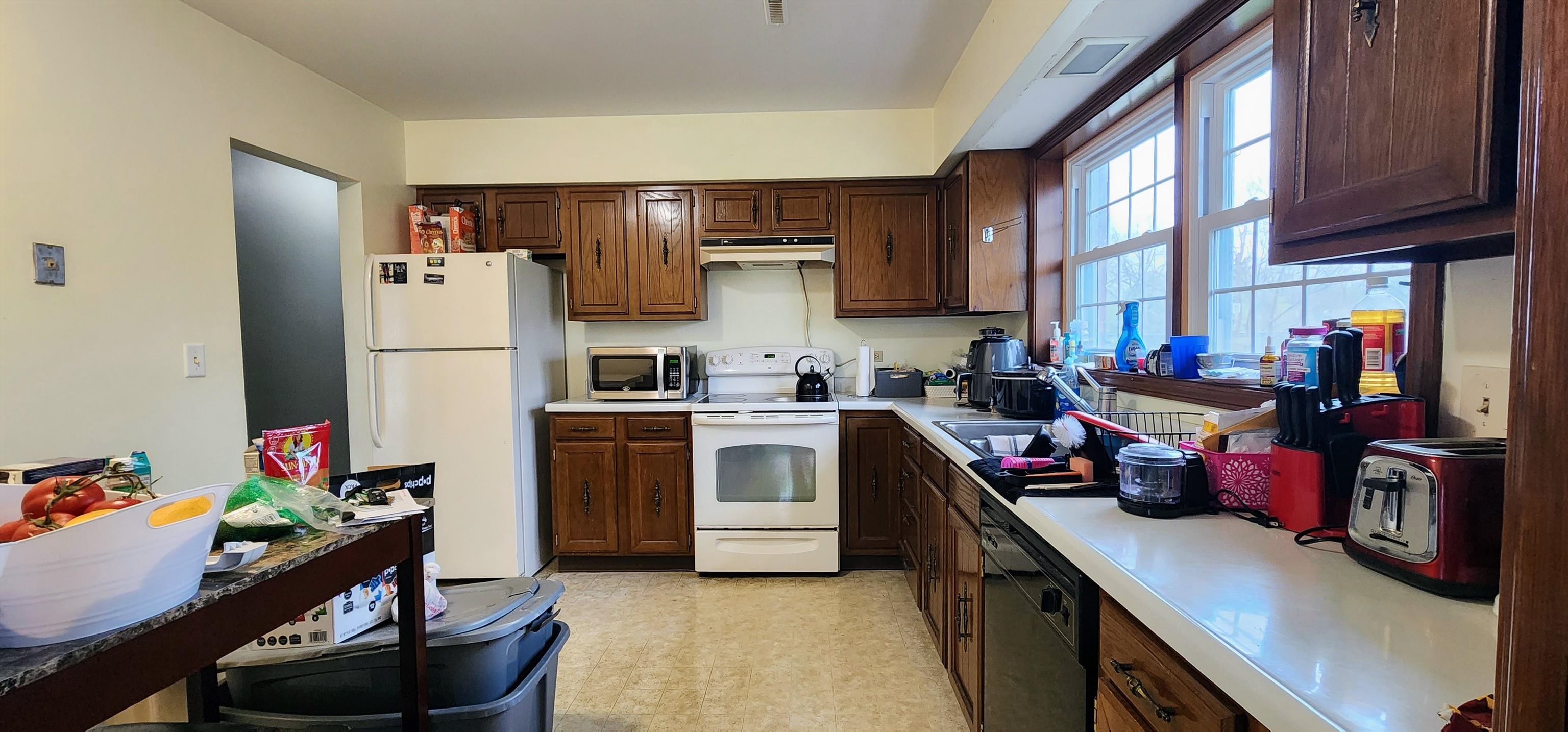 1450 Wing Street Elgin, IL 60123 - Photo 8 of 36 a kitchen with a refrigerator and a stove top oven