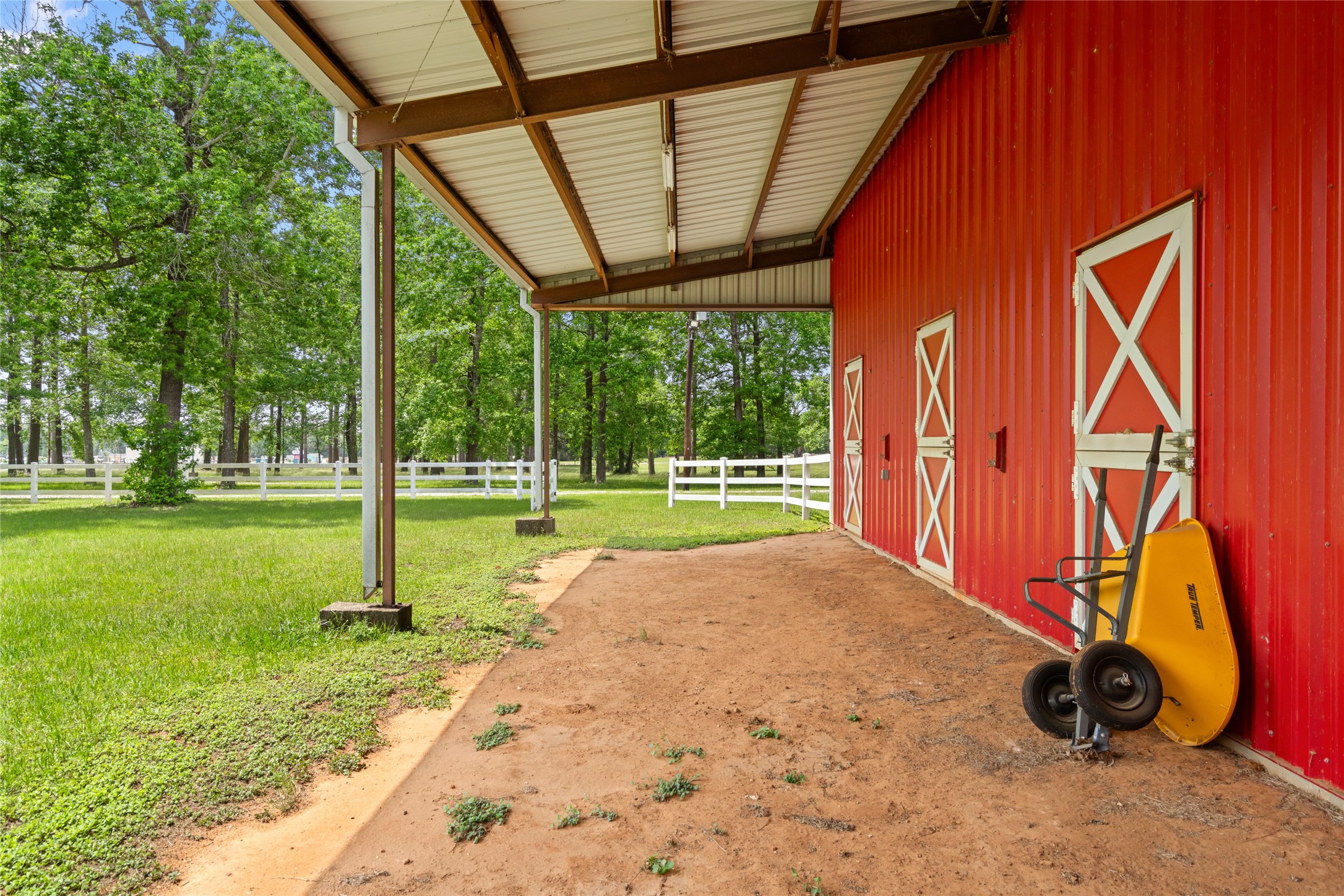 15126 Walden Road Montgomery, TX 77356 - Photo 21 of 50 Cozy side covered area of the barn, a protected space for storage, seating, or equipment out of the elements.