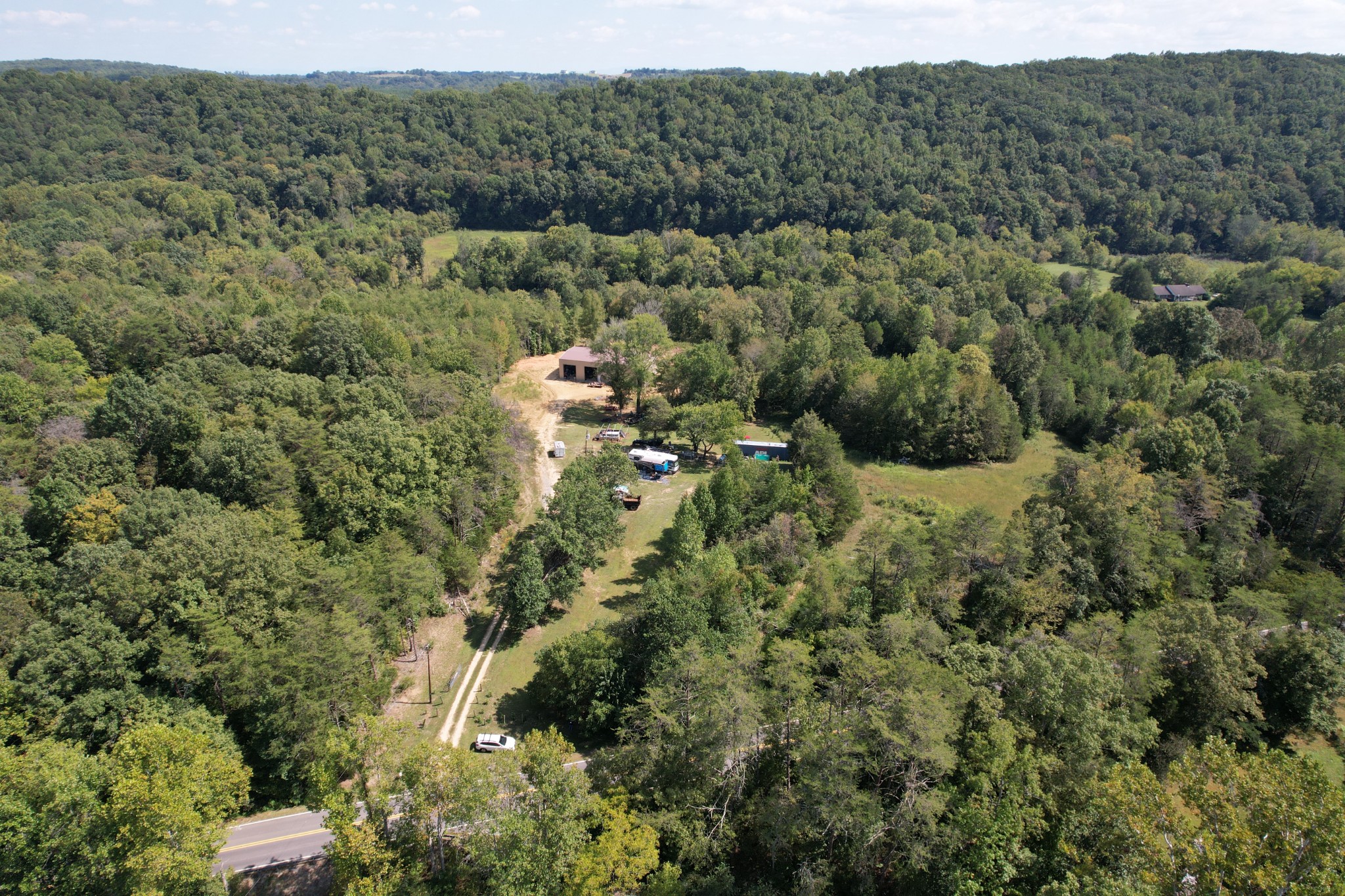 703 Sweetwater Road Philadelphia, TN 37846 - Photo 17 of 34 a view of a forest with a street