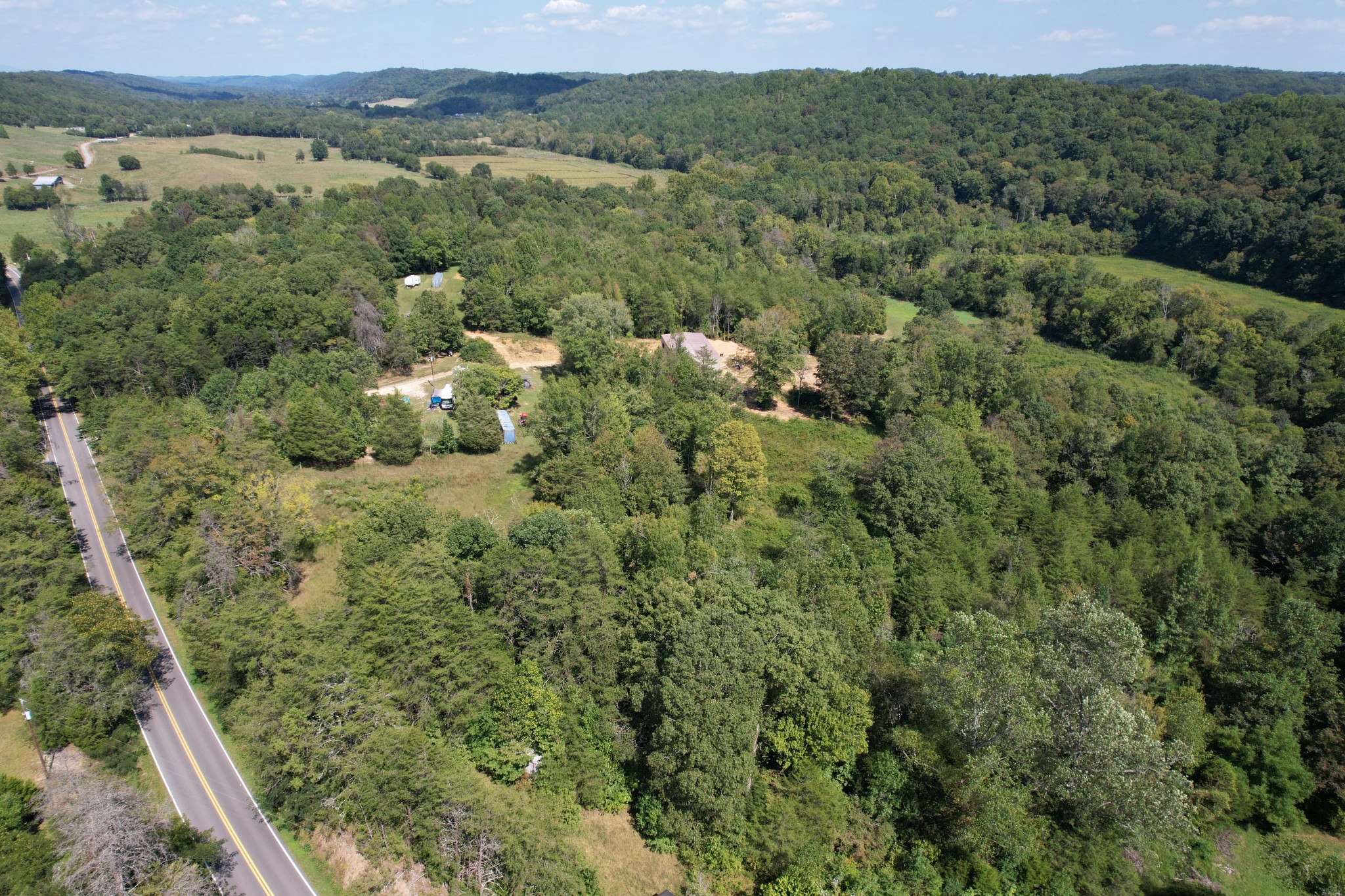 703 Sweetwater Road Philadelphia, TN 37846 - Photo 19 of 34 an aerial view of a houses with a lush green hillside