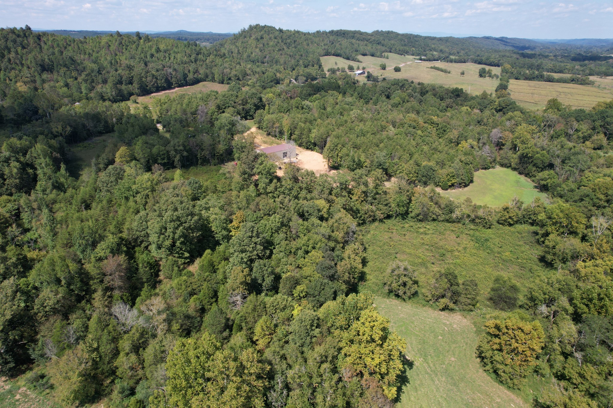 703 Sweetwater Road Philadelphia, TN 37846 - Photo 21 of 34 a view of a lake with green field and mountains