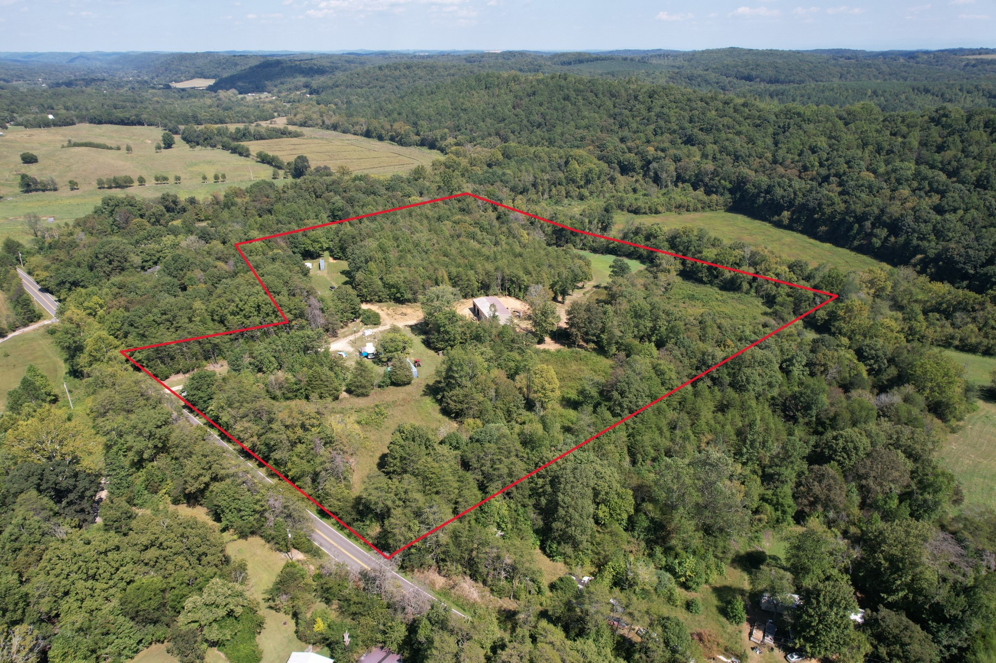 703 Sweetwater Road Philadelphia, TN 37846 - Photo 3 of 34 a view of a lake with green field and mountains