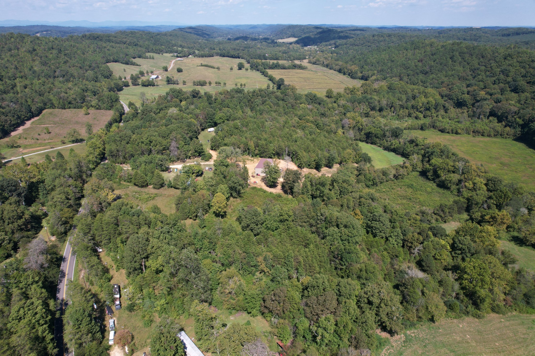 703 Sweetwater Road Philadelphia, TN 37846 - Photo 8 of 34 an aerial view of a houses with a lush green hillside