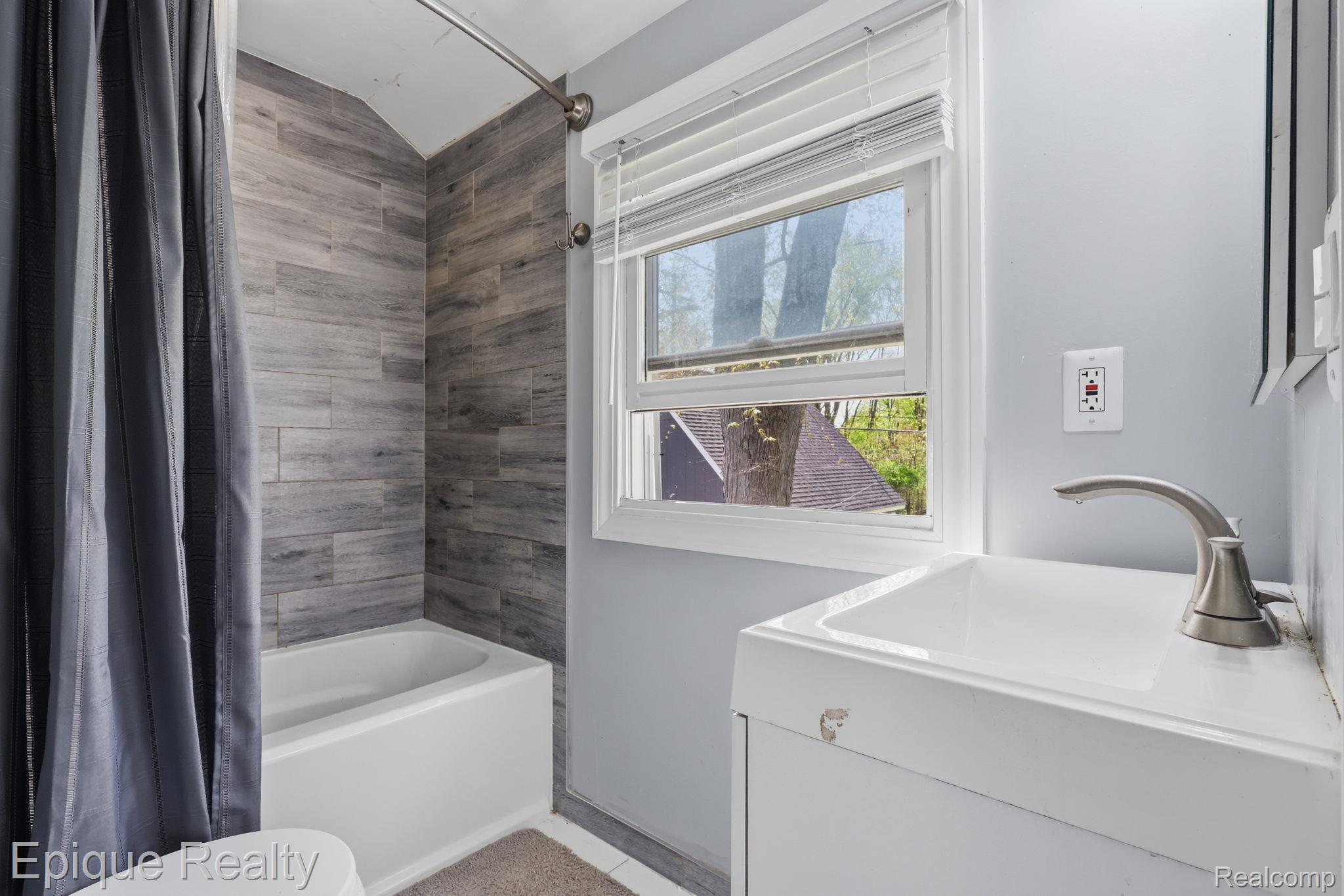 7441 Honeysuckle Road West Bloomfield, MI 48324 - Photo 24 of 35 Full bathroom featuring vanity and shower / bath combo with shower curtain