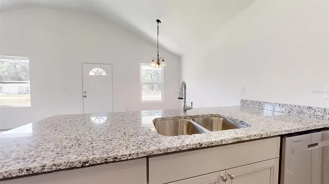 a kitchen with granite countertop a sink and a granite counter tops
