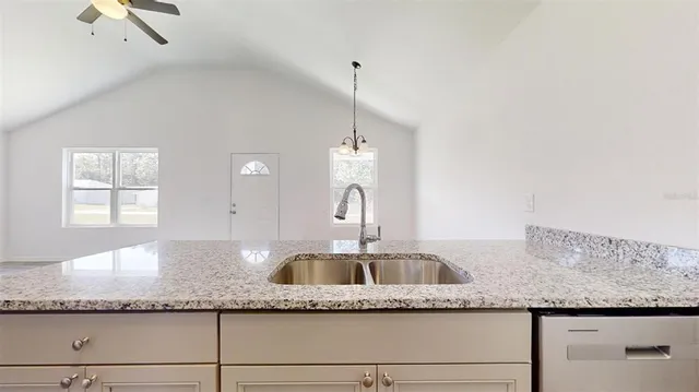 a kitchen with granite countertop a sink and a granite counter tops