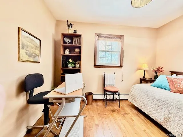 a bedroom with furniture and a wooden floor