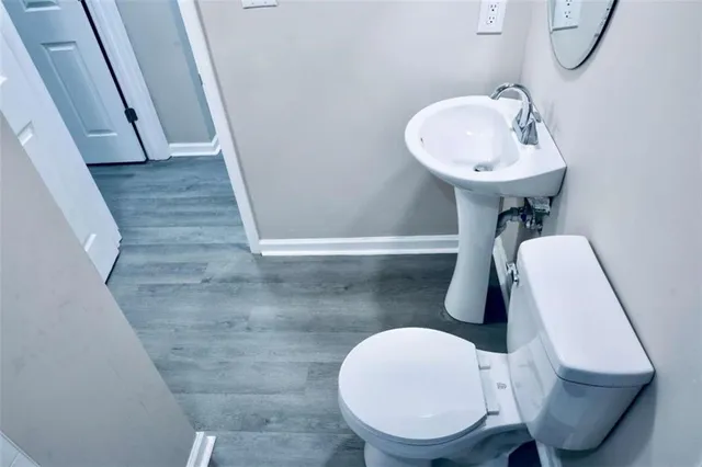 a bathroom with a toilet sink and mirror