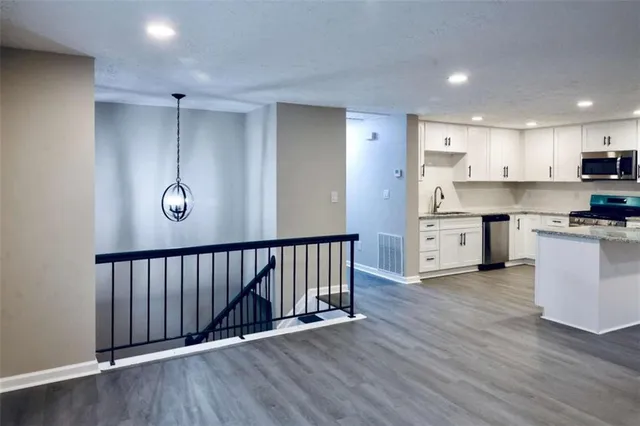 a view of kitchen with wooden floor and electronic appliances