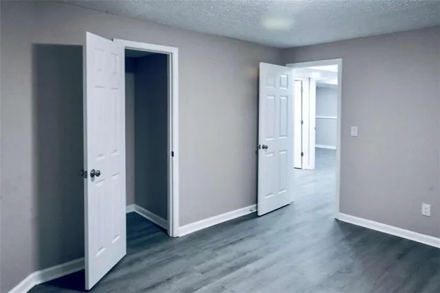 a view of a room with wooden floor