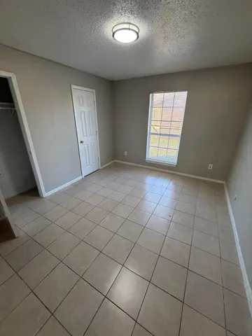 a kitchen with granite countertop a sink a stove and cabinets