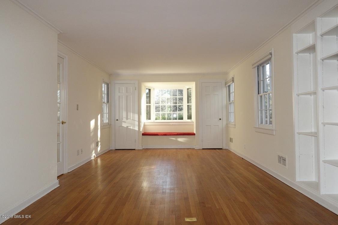 24 Hendrie Avenue Riverside, CT 06878 - Photo 8 of 33 a view of an empty room with wooden floor and a window