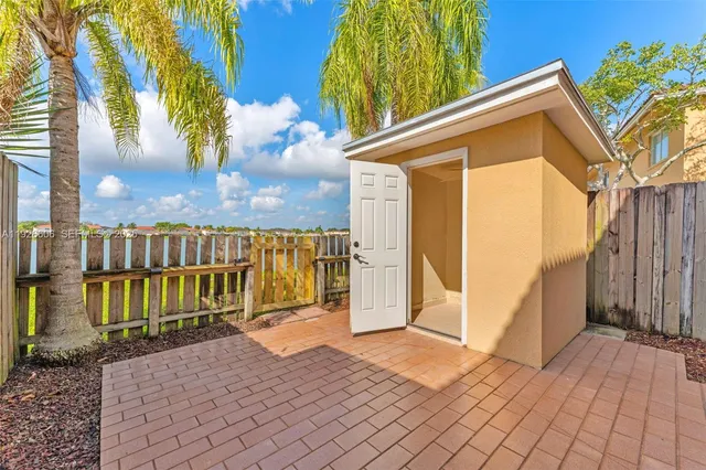 a view of a house with wooden fence