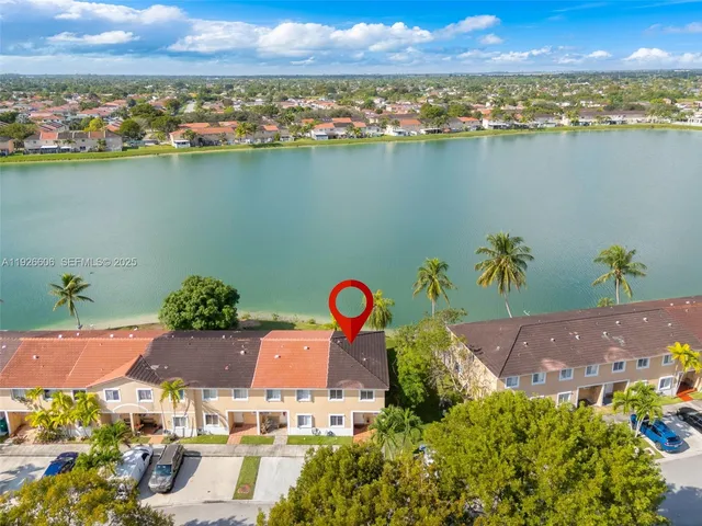 an aerial view of a house with a swimming pool outdoor seating and yard