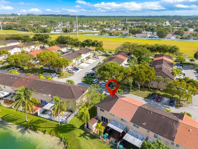 an aerial view of residential houses with outdoor space and river