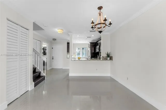 a view of hallway with chandelier and a chandelier