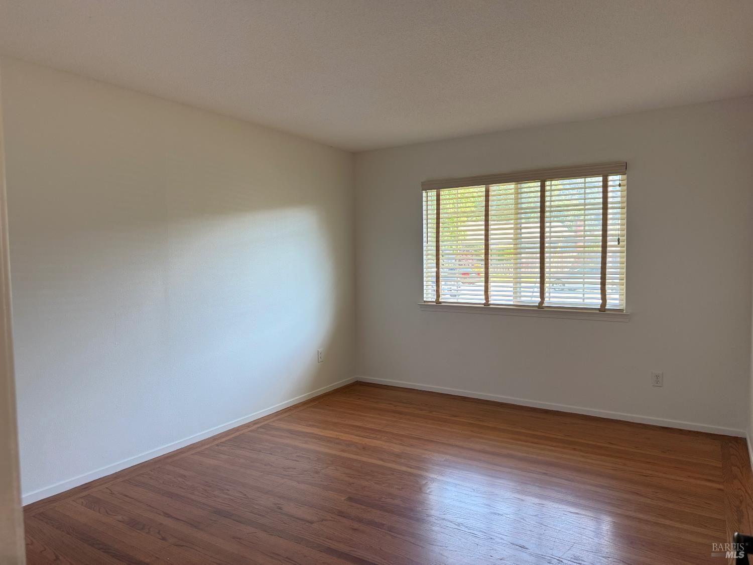2553 Cactus Avenue Santa Rosa, CA 95405 - Photo 8 of 15 a view of an empty room with wooden floor and a window