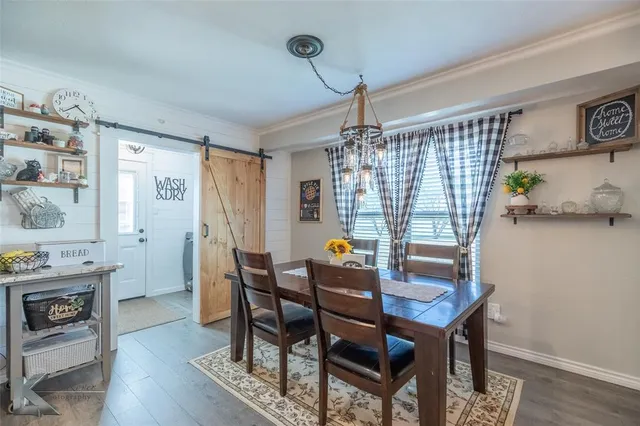 a dining room with furniture and window