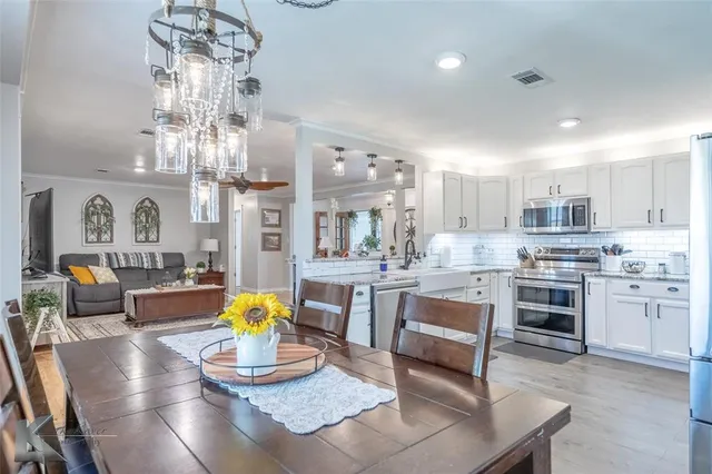 a kitchen with stainless steel appliances granite countertop a stove refrigerator and cabinets