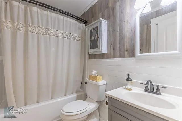 a bathroom with a toilet a sink and a mirror