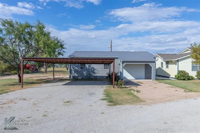 a view of a house with roof and parking