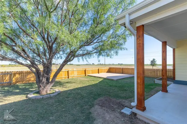 a work room with wooden floor and furniture