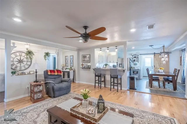 a living room with furniture a dining table and a flat screen tv