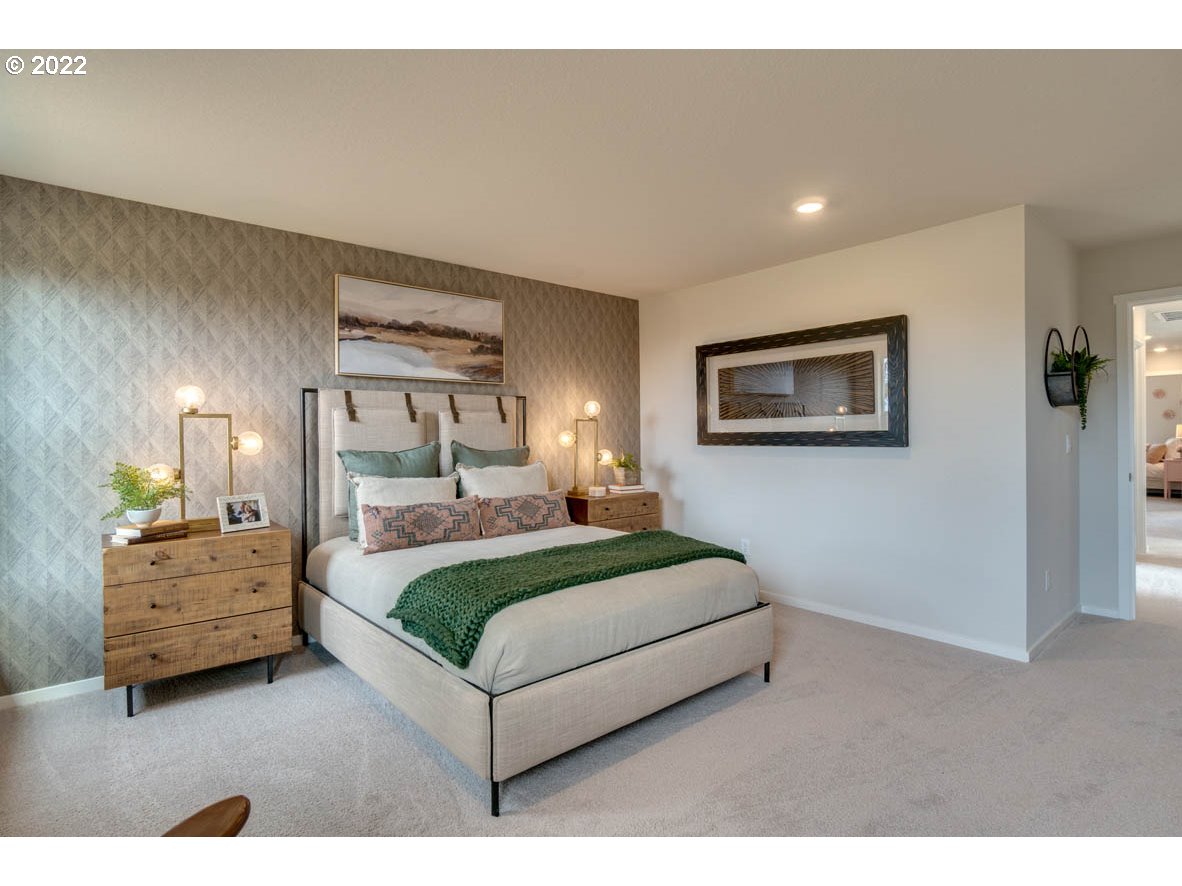 240 Northeast 28th Court Ridgefield, WA 98642 - Photo 29 of 32 a bedroom with a bed and lamp