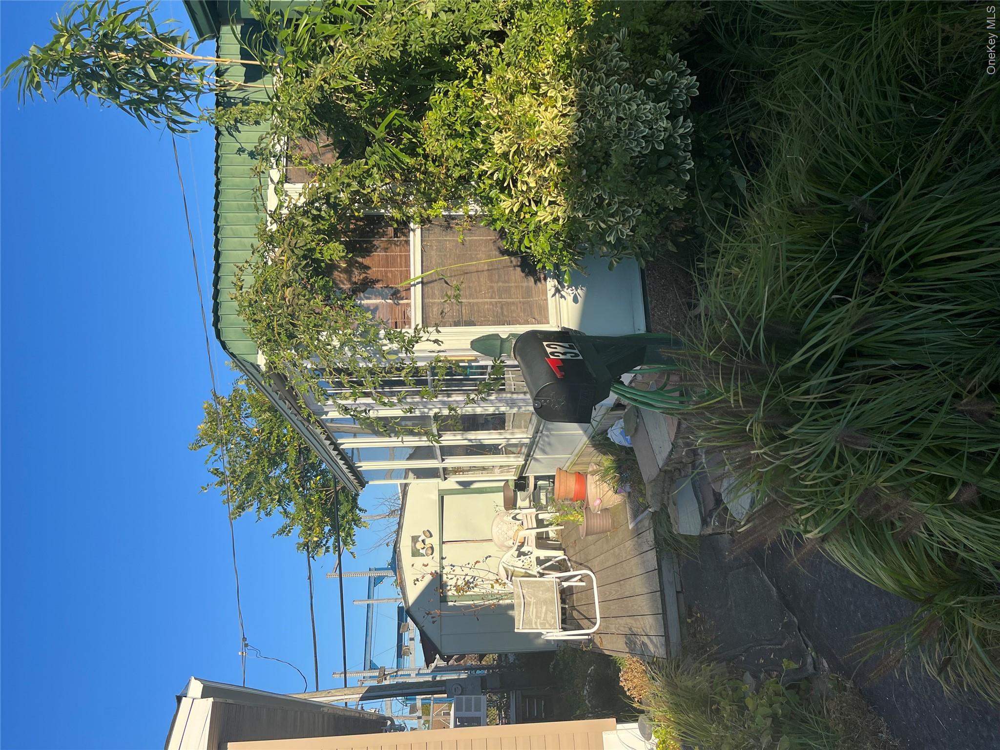 150 Main Street, Unit 32 Islip, NY 11751 - Photo 3 of 5 View of patio featuring a wooden deck