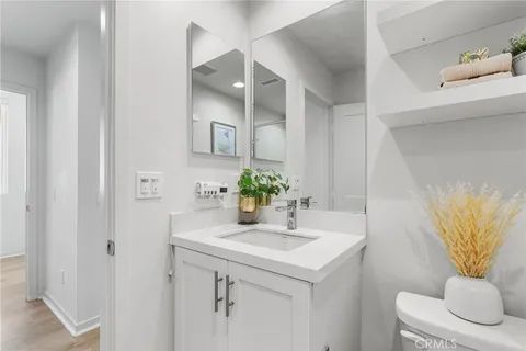 a bathroom with a sink a toilet and a mirror