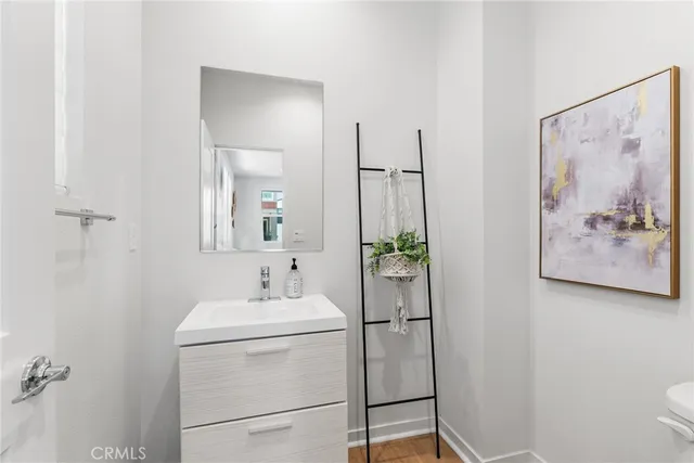 a bathroom with a sink and mirror with toilet