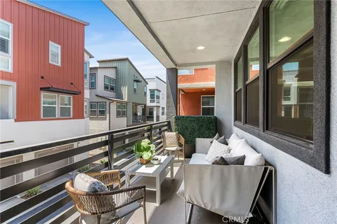 a view of a patio with couches table and chairs and potted plants