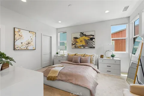 a bedroom with a bed and painting on the wall