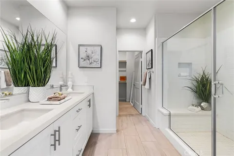 a bathroom with a sink a mirror and a shower