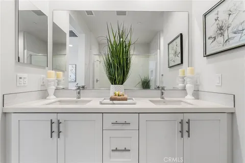 a bathroom with cabinets sink and mirror