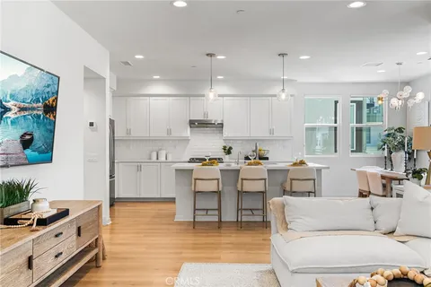 a living room with furniture and kitchen view