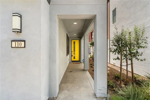 a view of a hallway with wooden floor and a glass door