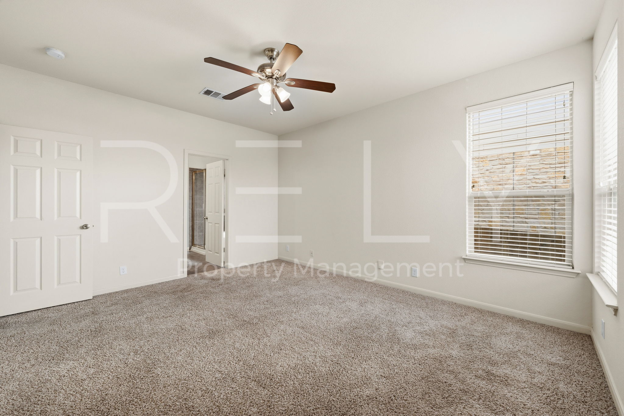 1405 Sunny Meadows Loop Georgetown, TX 78626 - Photo 17 of 40 A well-lit bedroom offering a cozy retreat with ample space and a cooling ceiling fan.