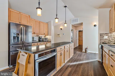 a view of a hall way with furniture and floor to ceiling window