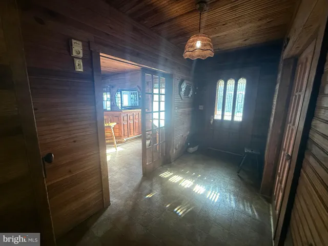 a living room with furniture and floor to ceiling windows