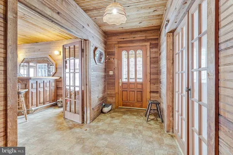 a view of a livingroom with furniture and a large window