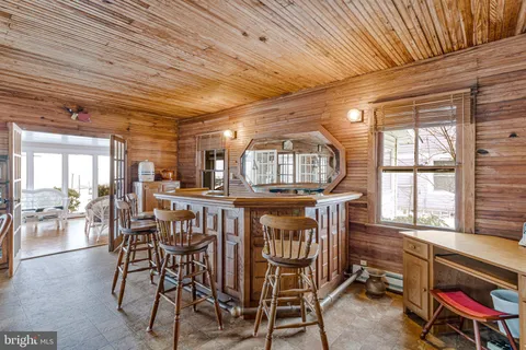 a bathroom with a granite countertop toilet sink and mirror