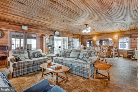 a view of a white house with a yard covered in snow