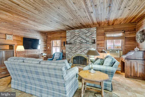 a view of a house with a yard covered in snow